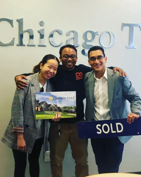 Nestor Icaza's clients holding a SOLD sign on closing day for their San Bruno or Peninsula home