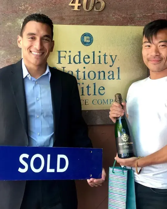 Nestor Icaza's clients holding a SOLD sign on closing day for their San Bruno or Peninsula home