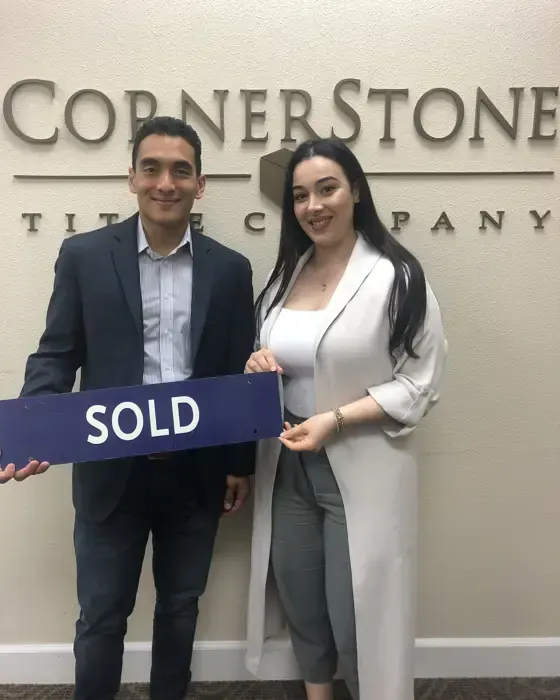 Nestor Icaza's clients holding a SOLD sign on closing day for their San Bruno or Peninsula home