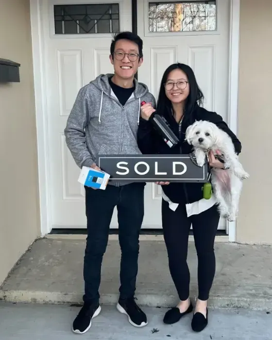 Nestor Icaza's clients holding a SOLD sign on closing day for their San Bruno or Peninsula home