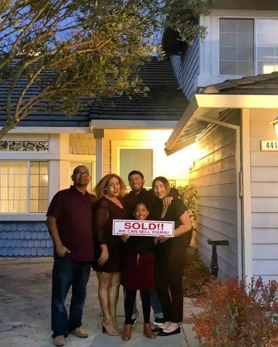 Nestor Icaza's clients holding a SOLD sign on closing day for their San Bruno or Peninsula home