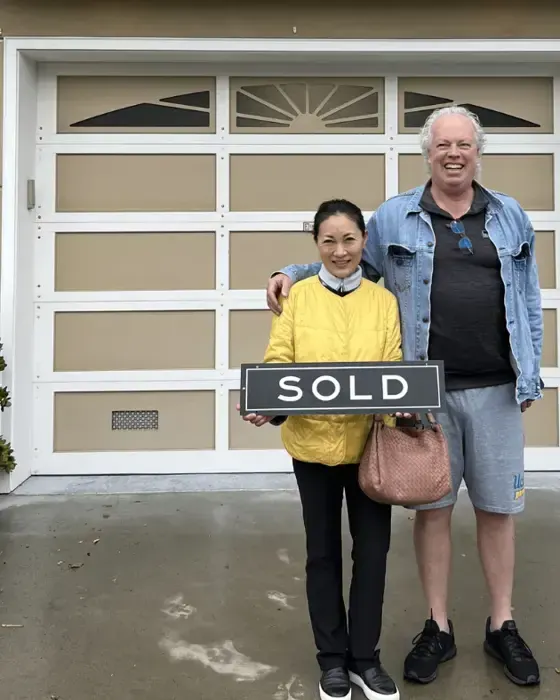 Nestor Icaza's clients holding a SOLD sign on closing day for their San Bruno or Peninsula home