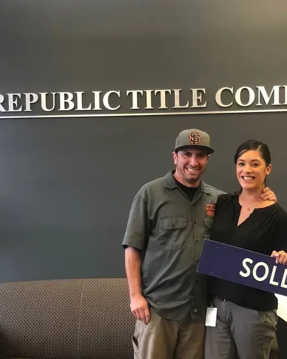 Nestor Icaza's clients holding a SOLD sign on closing day for their San Bruno or Peninsula home